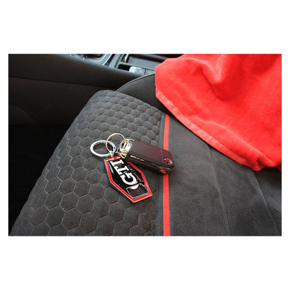 VW GTI nøglering med flaskeåbner, sort, vist på bilsæde