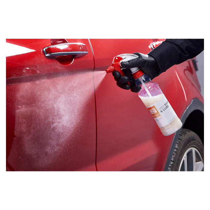 Spraying Autoglym Fallout Remover on a red car to remove rust