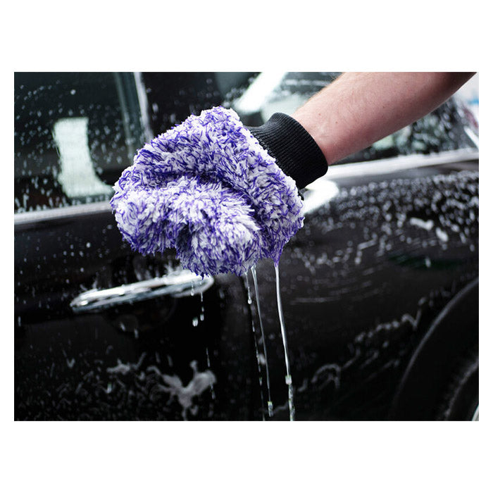 Hånd med Autoglym Polar mikrofiber vaskehandsken fjerner shampoo fra en sort bil