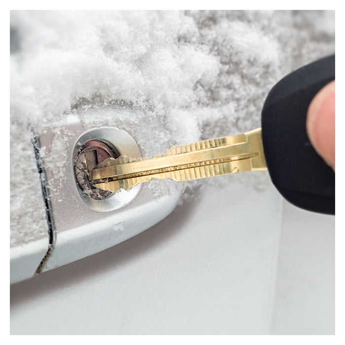 Nøgle i en frossen billås dækket af sne